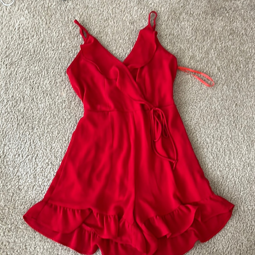Red spaghetti strap surplice romper with ruffle edge